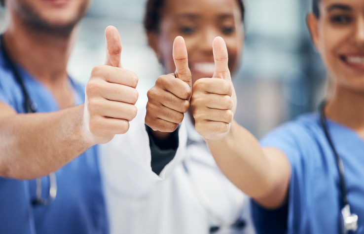 Doctors, nurses or thumbs up hands in success, teamwork collaboration or trust with medical winner goal. Zoom on thank you, motivation and vote gesture on man and support women in healthcare hospital
